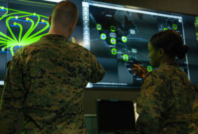 Marines with Marine Corps Forces Cyberspace Command pose for photos in the cybersecurity operations center at Lasswell Hall aboard Fort Meade, Maryland.