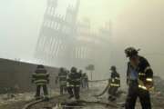 THEN-- With the skeleton of the World Trade Center twin towers in the background, New York City firefighters work amid debris on Cortlandt St. after the terrorist attacks of Tuesday, Sept. 11, 2001.  (AP Photo/Mark Lennihan)