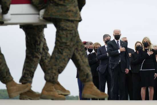 President Joe Biden and first lady Jill Biden watch as a carry team moves a transfer case containing the remains of Marine Corps Lance Cpl. Kareem M. Nikoui, 20, of Norco, Calif., during a casualty return Sunday, Aug. 29, 2021, at Dover Air Force Base, Del. According to the Department of Defense, Nikoui died in an attack at Afghanistan's Kabul airport, along with 12 other U.S. service members. (AP Photo/Carolyn Kaster)