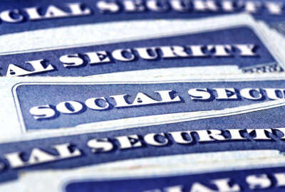 Closeup detail of several Social Security Cards representing finances and retirement