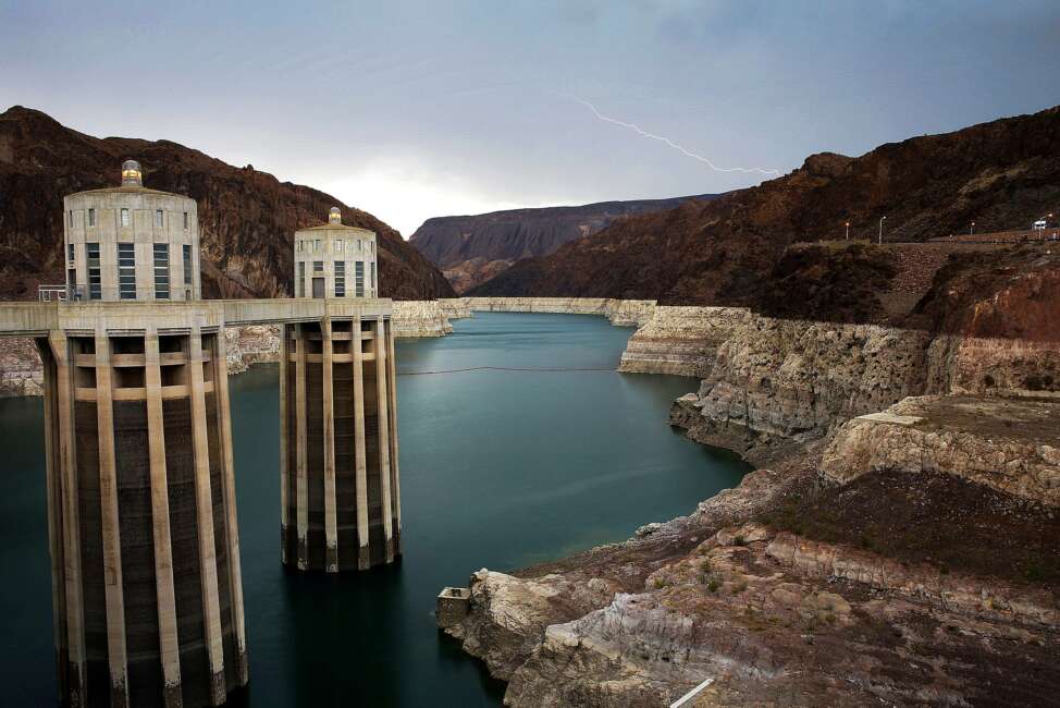 FILE - In this July 28, 2014, file photo, lightning strikes over Lake Mead near Hoover Dam that impounds Colorado River water at the Lake Mead National Recreation Area in Arizona. The sweeping $1 trillion infrastructure bill approved by the Senate this week includes funding for Western water projects that farmers, water providers and environmentalists say are badly needed across the parched region. (AP Photo/John Locher, File)