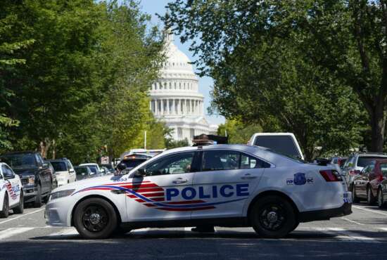 A Metropolitan Police Department cruiser blocks a street near the U.S. Capitol and a Library of Congress building in Washington on Thursday, Aug. 19, 2021, as law enforcement officials investigate a report of a pickup truck containing an explosive device. (AP Photo/Patrick Semansky)
