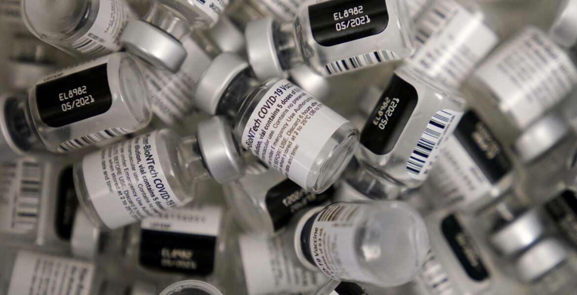 FILE - In this Jan. 22, 2021, file photo, used vials of the Pfizer-BioNTech COVID-19 vaccine lay empty at a vaccination center at the University of Nevada in Las Vegas. The U.S. government announced on Aug. 11, 2021 it will deliver Pfizer vaccines to the Caribbean. (AP Photo/John Locher, File)
