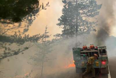 In this photo provided by the United States Forest Service, firefighters battle a wildfire, Monday, Aug. 23, 2021, near Greenwood Lake in the Superior National Forest of northeastern Minnesota. The fire has burned more than 14 square miles and promoted a new round of evacuations of homes and cabins on Monday. (United States Forest Service via AP)