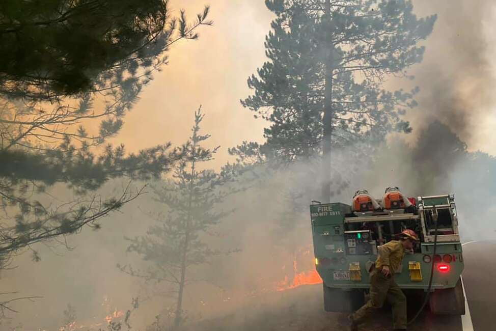 In this photo provided by the United States Forest Service, firefighters battle a wildfire, Monday, Aug. 23, 2021, near Greenwood Lake in the Superior National Forest of northeastern Minnesota. The fire has burned more than 14 square miles and promoted a new round of evacuations of homes and cabins on Monday. (United States Forest Service via AP)