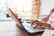 Woman working from home using notebook computer.