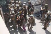 FILE - In this Aug. 20, 2021, file photo provided by the U.S. Marine Corps, U.S. Marines and Norweigian coalition forces assist with security at an Evacuation Control Checkpoint ensuring evacuees are processed safely during an evacuation at Hamid Karzai International Airport in Kabul, Afghanistan. (Staff Sgt. Victor Mancilla/U.S. Marine Corps via AP, File)