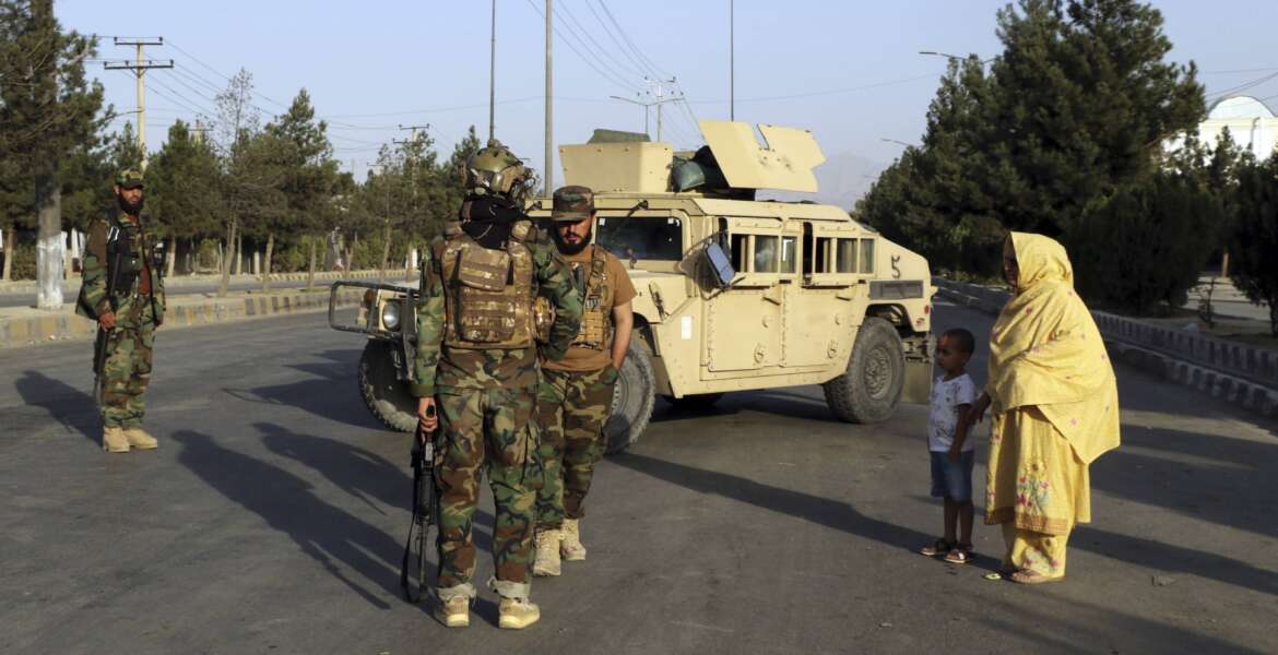 Taliban fighters stand guard at a checkpoint near the gate of Hamid Karzai international Airport in Kabul, Afghanistan, Saturday, Aug. 28, 2021.  The Taliban have sealed off Kabul’s airport to most would-be evacuees to prevent large crowds from gathering after this week's deadly suicide attack. The massive U.S.-led airlift was winding down Saturday ahead of a U.S. deadline to withdraw from Afghanistan by Tuesday. (AP Photo/Wali Sabawoon)