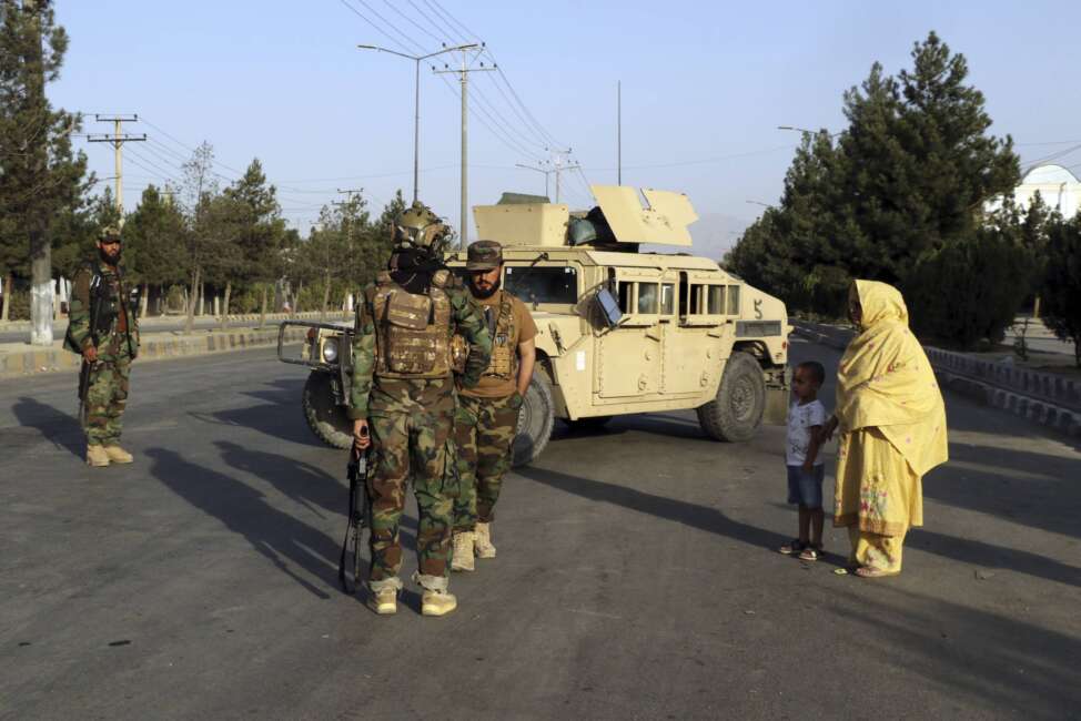 Taliban fighters stand guard at a checkpoint near the gate of Hamid Karzai international Airport in Kabul, Afghanistan, Saturday, Aug. 28, 2021.  The Taliban have sealed off Kabul’s airport to most would-be evacuees to prevent large crowds from gathering after this week's deadly suicide attack. The massive U.S.-led airlift was winding down Saturday ahead of a U.S. deadline to withdraw from Afghanistan by Tuesday. (AP Photo/Wali Sabawoon)