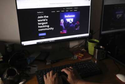 A man visits a hacker community website at a house in Jakarta, Indonesia, Monday, Sept. 20, 2021. Indonesian authorities have found no evidence that the country's main intelligence service's computers were compromised, after a U.S.-based private cybersecurity company alerted them of a suspected breach of its internal networks by a Chinese hacking group, an official said. (AP Photo/Tatan Syuflana)