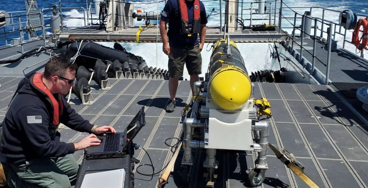 In this handout image from the U.S. Navy, sailors prepare a CARINA unmanned undersea drone off San Diego, California, April 19, 2021. The U.S. Navy's Mideast-based 5th Fleet said Wednesday, Sept. 8, 2021, it will launch a new task force that incorporates airborne, sailing and underwater drones after years of maritime attacks linked to ongoing tensions with Iran. (U.S. Navy/Lt. Cmdr. Tony Wright, via AP)