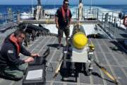 In this handout image from the U.S. Navy, sailors prepare a CARINA unmanned undersea drone off San Diego, California, April 19, 2021. The U.S. Navy's Mideast-based 5th Fleet said Wednesday, Sept. 8, 2021, it will launch a new task force that incorporates airborne, sailing and underwater drones after years of maritime attacks linked to ongoing tensions with Iran. (U.S. Navy/Lt. Cmdr. Tony Wright, via AP)