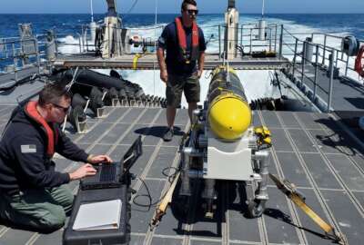 In this handout image from the U.S. Navy, sailors prepare a CARINA unmanned undersea drone off San Diego, California, April 19, 2021. The U.S. Navy's Mideast-based 5th Fleet said Wednesday, Sept. 8, 2021, it will launch a new task force that incorporates airborne, sailing and underwater drones after years of maritime attacks linked to ongoing tensions with Iran. (U.S. Navy/Lt. Cmdr. Tony Wright, via AP)