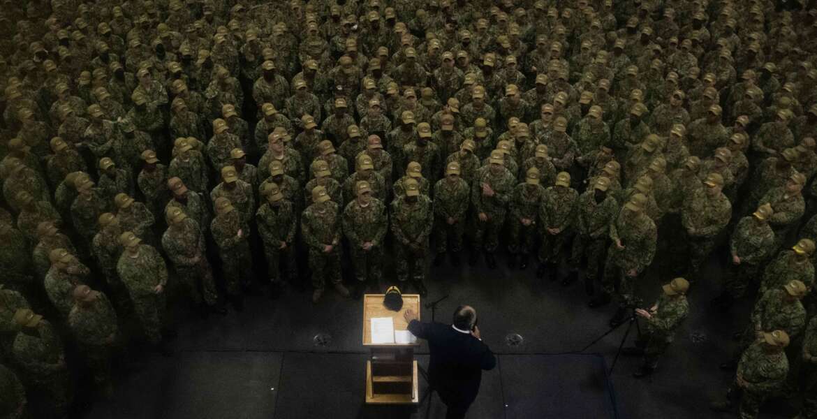 211026-N-DK722-1237 YOKOSUKA, Japan (Oct. 26, 2021) – Secretary of the Navy Carlos Del Toro speaks to the crew during an all hands call in the hangar bay of the U.S. Navy’s only forward-deployed aircraft carrier USS Ronald Reagan (CVN 76). Ronald Reagan, the flagship of Carrier Strike Group 5, provides a combat-ready force that protects and defends the United States, and supports alliances, partnerships and collective maritime interests in the Indo-Pacific region. (U.S. Navy Photo by Mass Communication Specialist 2nd Class Cameron C. Edy)