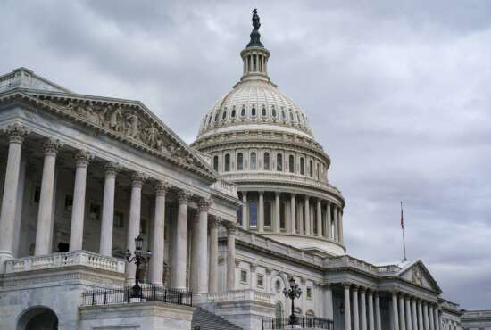 The Capitol is seen as members of the House of Representatives vote on a short-term lift of the nation's debt limit and ensure the federal government can continue fully paying its bills into December, at the Capitol in Washington, Tuesday, Oct. 12, 2021. (AP Photo/J. Scott Applewhite)