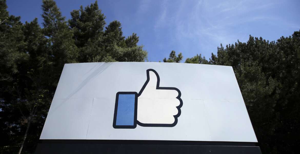 FILE - In this April 14, 2020 file photo, the thumbs up Like logo is shown on a sign at Facebook headquarters in Menlo Park, Calif. The term metaverse seems to be everywhere. Facebook is hiring thousands of engineers in Europe to work on it, while video game companies are outlining their long-term visions for what some consider the next big thing on the internet. Essentially, it’s a world of endless, interconnected virtual communities where people can meet, work and play. You can go to a virtual concert, take a trip online and try on digital clothing. But tech companies still have to figure out how to connect their online platforms.(AP Photo/Jeff Chiu, File)