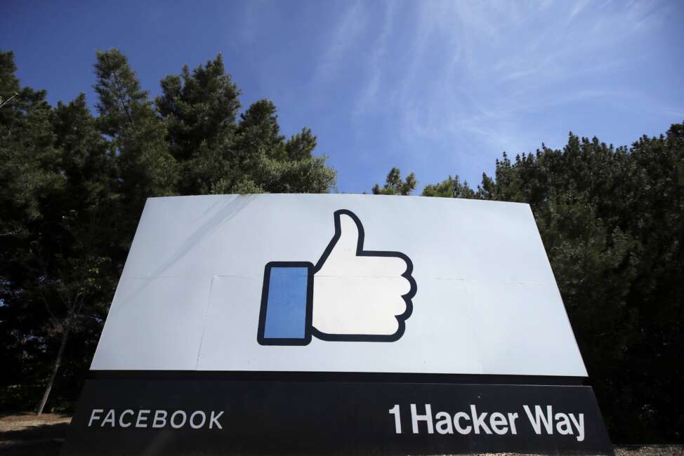 FILE - In this April 14, 2020 file photo, the thumbs up Like logo is shown on a sign at Facebook headquarters in Menlo Park, Calif. The term metaverse seems to be everywhere. Facebook is hiring thousands of engineers in Europe to work on it, while video game companies are outlining their long-term visions for what some consider the next big thing on the internet. Essentially, it’s a world of endless, interconnected virtual communities where people can meet, work and play. You can go to a virtual concert, take a trip online and try on digital clothing. But tech companies still have to figure out how to connect their online platforms.(AP Photo/Jeff Chiu, File)