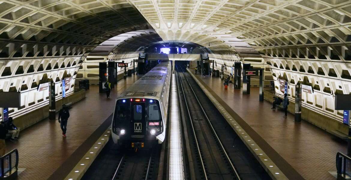 FILE - In this April 23, 2021 file photo, a train arrives at Metro Center station in Washington.  Washington’s regional Metro system abruptly pulled more than half its fleet of trains from service early Monday morning over a lingering problem with the wheels and axles that caused a dramatic derailing last week.  (AP Photo/Patrick Semansky)
