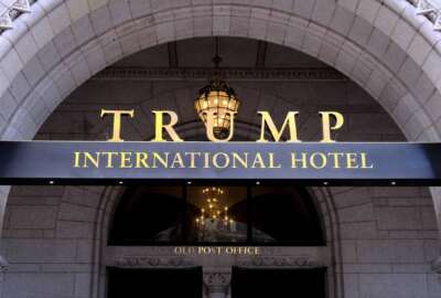 FILE - This March 11, 2019 file photo, shows the north entrance of the Trump International in Washington.  Former President Donald Trump's company lost more than $70 million operating his Washington D.C. hotel while in office, forcing him at one point get a reprieve from a major bank on payments on a loan, according to documents released Friday, Oct. 8, 2021, by a House committee investigating his business. (AP Photo/Mark Tenally, File)