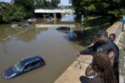 FILE - In this Thursday, Sept 2, 2021 file photo, vehicles are stranded by high water on the Major Deegan Expressway in the Bronx borough of New York as high water left behind by Hurricane Ida still stands on the highway hours later. According to a United Nations report released on Tuesday, Oct. 5, 2021, much of the world is unprepared for the floods, hurricanes and droughts expected to worsen with climate change and urgently needs better warning systems to avert water-related disasters. (AP Photo/Craig Ruttle)