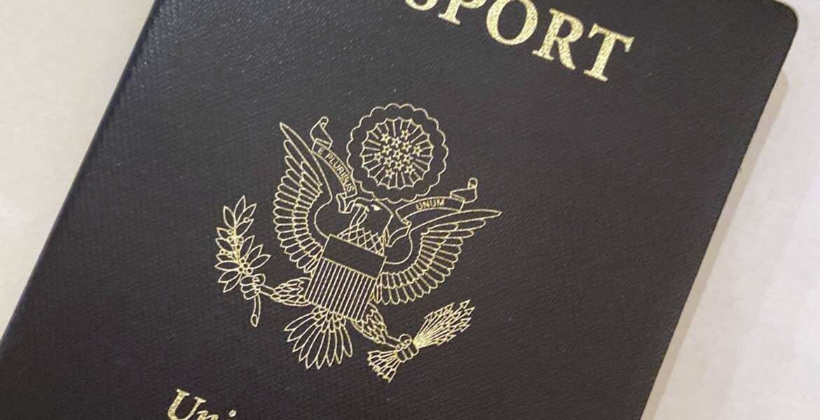 FILE - This May 25, 2021 file photo shows a U.S. Passport cover in Washington. The United States has issued its first passport with an “X” gender designation, a milestone in the recognition of the rights of people who don't identify as male or female.  (AP Photo/Eileen Putman)