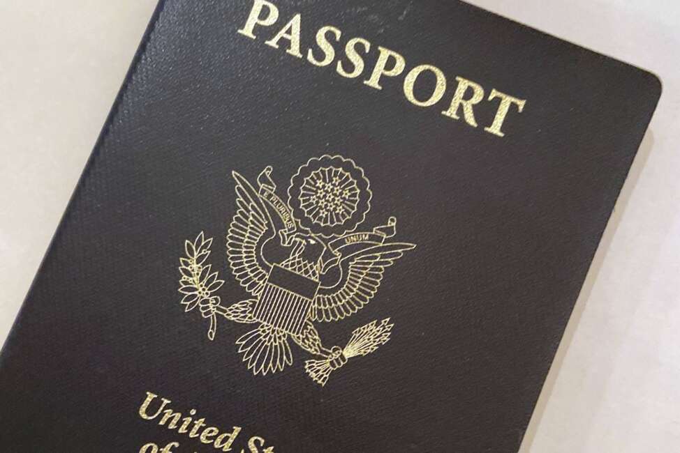 FILE - This May 25, 2021 file photo shows a U.S. Passport cover in Washington. The United States has issued its first passport with an “X” gender designation, a milestone in the recognition of the rights of people who don't identify as male or female.  (AP Photo/Eileen Putman)