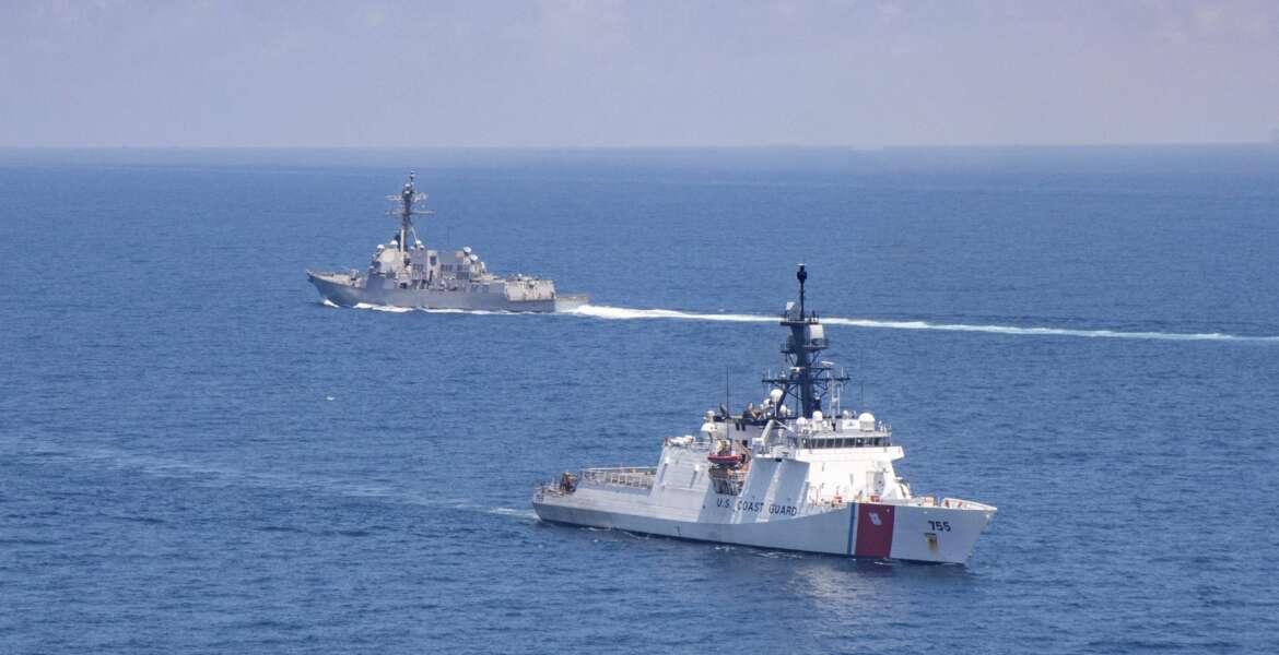 FILE - In this Aug. 27, 2021, file photo provided by U.S. Coast Guard, Legend-class U.S. Coast Guard National Security Cutter Munro (WMSL 755) transits the Taiwan Strait during a routine transit with Arleigh Burke class guided-missile destroyer USS Kidd (DDG 100). The United States and China are stepping up their war of words over Taiwan in a long-simmering dispute that has significant implications for the power dynamic in the Indo-Pacific and beyond. (U.S. Coast Guard via AP, File)