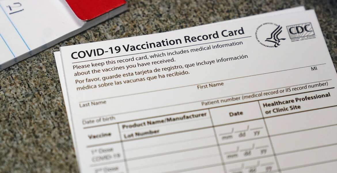 FILE - In this Dec. 24, 2020, file photo, a COVID-19 vaccination record card is shown at Seton Medical Center in Daly City, Calif. Los Angeles leaders are poised to enact one of the nation's strictest vaccine mandates, a sweeping measure that would require the shots for everyone entering a bar, restaurant, nail salon, gym or even a Lakers game. The City Council on Wednesday, Oct. 6, 2021, is scheduled to consider the proposal and most members have said they support it as a way of preventing further COVID-019 surges. (AP Photo/Jeff Chiu, File)