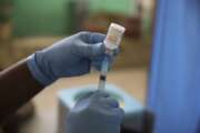 FILE - In this Tuesday, July 27, 2021 file photo, a medical worker prepares a shot of the Moderna vaccine during a vaccination campaign at Saint Damien Hospital in Port-au-Prince, Haiti. The White House says the U.S. has donated its 200 millionth COVID-19 shot to help vaccinate the rest of the world. The Biden administration is aiming to lead a global vaccination campaign even as it rolls out boosters for domestic use. (AP Photo/Joseph Odelyn, file)