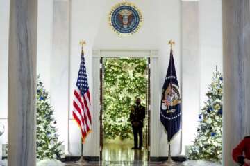 The Cross Hall of the White House is decorated for the holiday season during a press preview of the White House holiday decorations, Monday, Nov. 29, 2021, in Washington. (AP Photo/Evan Vucci)