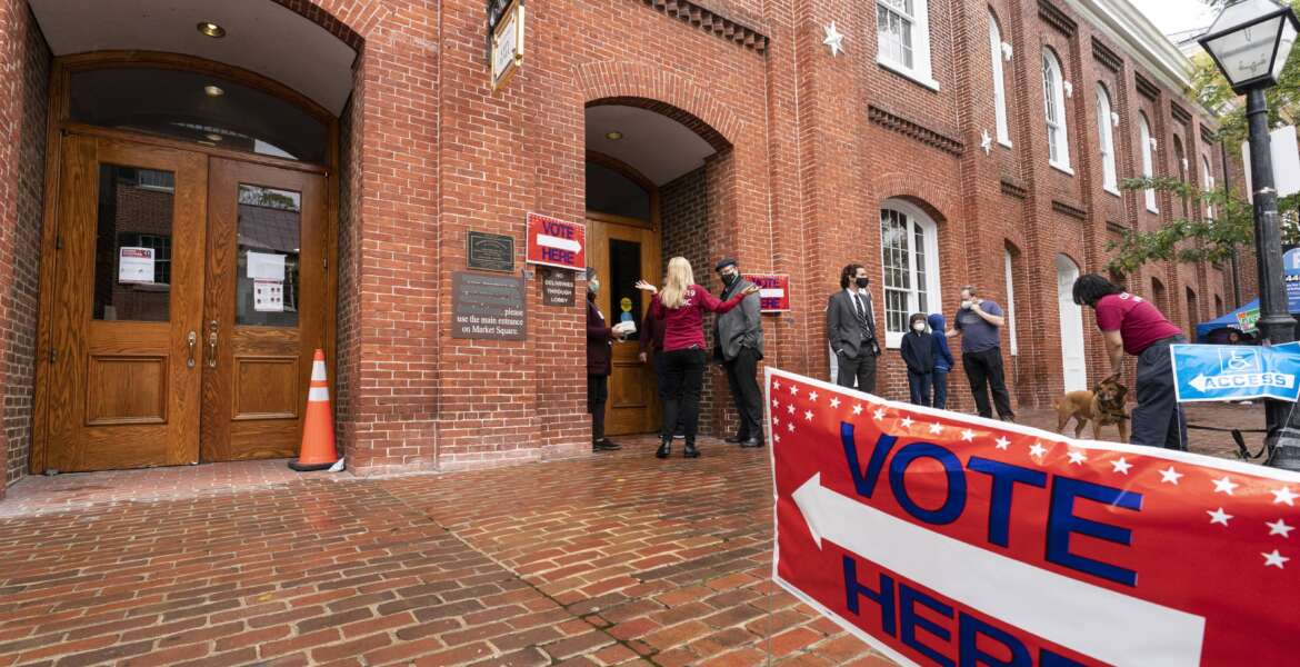 FILE - Voters arrive to cast the their ballots on Election Day at City Hall, Tuesday, Nov. 2, 2021, in Alexandria, Va. The first major election day following a year of relentless attacks on voting rights and election officials went off largely without a hitch. The relative calm was a relief to those who oversee state and local elections, but election experts say that might not matter to the millions of Americans who now believe in conspiracy theories trumpeting rampant electoral fraud. (AP Photo/Alex Brandon, File)