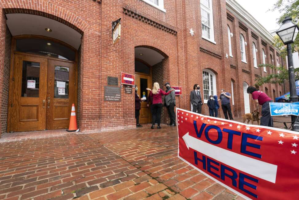 FILE - Voters arrive to cast the their ballots on Election Day at City Hall, Tuesday, Nov. 2, 2021, in Alexandria, Va. The first major election day following a year of relentless attacks on voting rights and election officials went off largely without a hitch. The relative calm was a relief to those who oversee state and local elections, but election experts say that might not matter to the millions of Americans who now believe in conspiracy theories trumpeting rampant electoral fraud. (AP Photo/Alex Brandon, File)