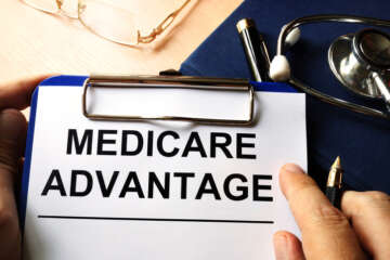 Medicare advantage in a clipboard. Health care insurance concept.