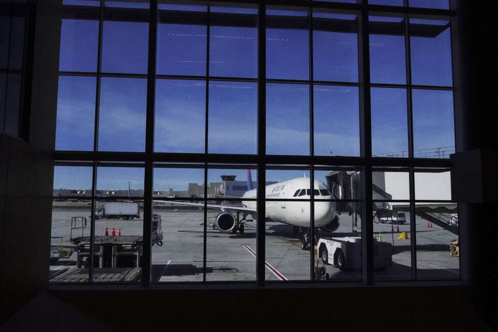 FILE - A plane prepares for a flight during holiday travel at the Hartsfield-Jackson Atlanta International Airport on Nov. 23, 2021, in Atlanta. Attorney General Merrick Garland directed U.S. attorneys across the country to swiftly prioritize prosecution of federal crimes that happen on commercial flights as federal officials face a historic number of investigations into passenger behavior. (AP Photo/Brynn Anderson, File)