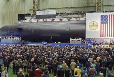 FILE - The United States Navy's nuclear-powered attack submarine USS Vermont is christened at Electric Boat in Groton, Conn., Oct. 20, 2018. A metallurgist in Washington state pleaded guilty to fraud Monday, Nov. 8, 2021, after she spent decades faking the results of strength tests on steel that was being used to make U.S. Navy submarines. Elaine Marie Thomas, 67, of Auburn, Wash., was the director of metallurgy at a foundry in Tacoma that supplied steel castings used by Navy contractors Electric Boat and Newport News Shipbuilding to make submarine hulls. (Sean D. Elliot/The Day via AP, File)