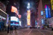 FILE — Confetti flies after the Times Square New Year's Eve ball drops in a nearly empty Times Square, in New York, early Jan. 1, 2021, as the area normally packed with revelers remained closed off due to the ongoing coronavirus pandemic. Crowds will once again fill New York's Times Square this New Year's Eve, with proof of COVID-19 vaccination required for revelers who want to watch the ball drop in person, Mayor Bill de Blasio announced Tuesday, Nov. 16, 2021. (AP Photo/Craig Ruttle, File)