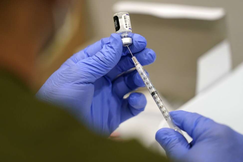 FILE - A healthcare worker fills a syringe with the Pfizer COVID-19 vaccine at Jackson Memorial Hospital, Oct. 5, 2021, in Miami. Nearly 8,500 active duty members of the Air Force and Space Force have missed the deadline for getting COVID-19 vaccinations, including 800 who flatly refused and nearly 5,000 with pending requests for a religious exemption, the Air Force said Wednesday, Nov. 3. (AP Photo/Lynne Sladky, File)