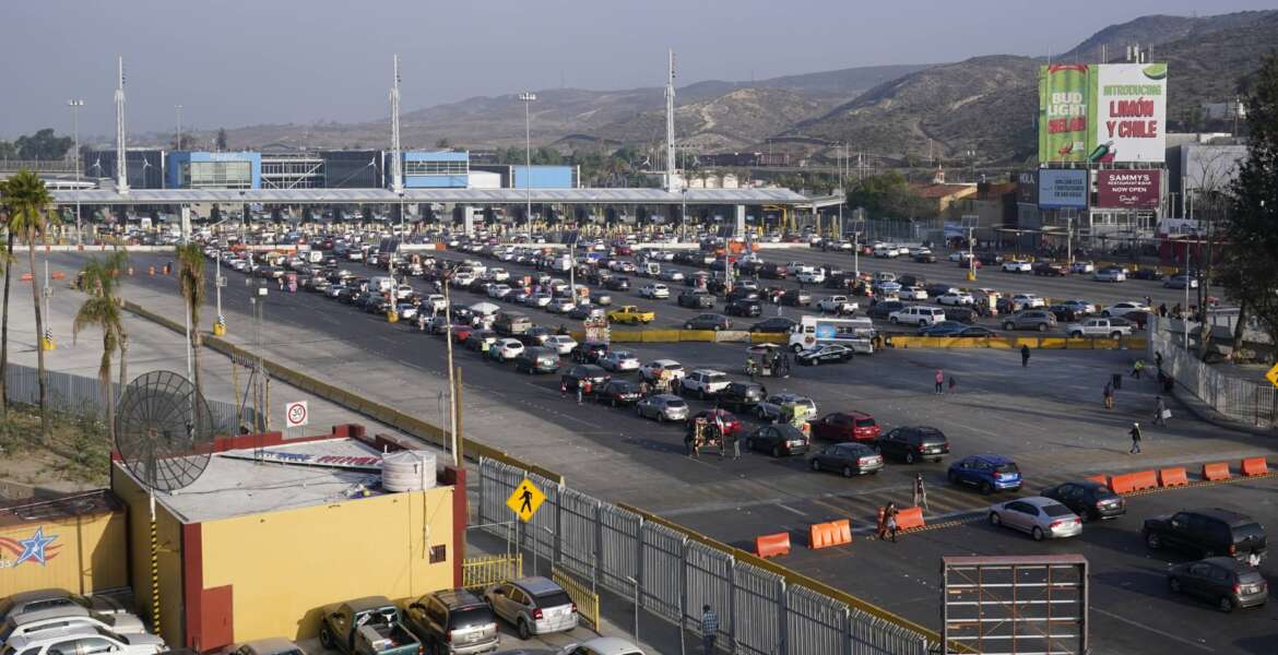 Cars wait to cross into the United States at the San Ysidro Port of Entry, Monday, Nov. 8, 2021, in Tijuana, Mexico. The U.S. fully reopened its borders with Mexico and Canada on Monday and lifted restrictions on travel that covered most of Europe, setting the stage for emotional reunions nearly two years in the making and providing a boost for the travel industry decimated by the pandemic. (AP Photo/Gregory Bull)