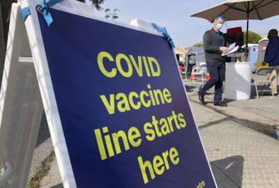 FILE - A sign is displayed at a COVID-19 vaccine site in the Bayview neighborhood of San Francisco on Feb. 8, 2021. The fate of President Joe Biden’s vaccine mandate for larger private employers may come down to a lottery that determines which federal circuit court will consider the matter. Conservative groups have filed challenges to the rule in right-leaning courts, while unions that argue the rule doesn’t go far enough have done so in left-leaning courts. The multiple cases are expected to be consolidated, and it will be up to a random drawing – expected on Tuesday -- to determine where that will be. (AP Photo/Haven Daley, File)