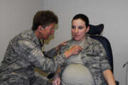 Airman First Class Brandy Fraher, who is in the final stages of her pregnancy, receives an examination from Major Noreen Burke during a unit training assembly. With restrictions, non flying pregnant Reservists may participate in all UTAs and annual tours until the 34th week of the pregnancy.