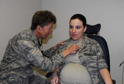 Airman First Class Brandy Fraher, who is in the final stages of her pregnancy, receives an examination from Major Noreen Burke during a unit training assembly. With restrictions, non flying pregnant Reservists may participate in all UTAs and annual tours until the 34th week of the pregnancy.