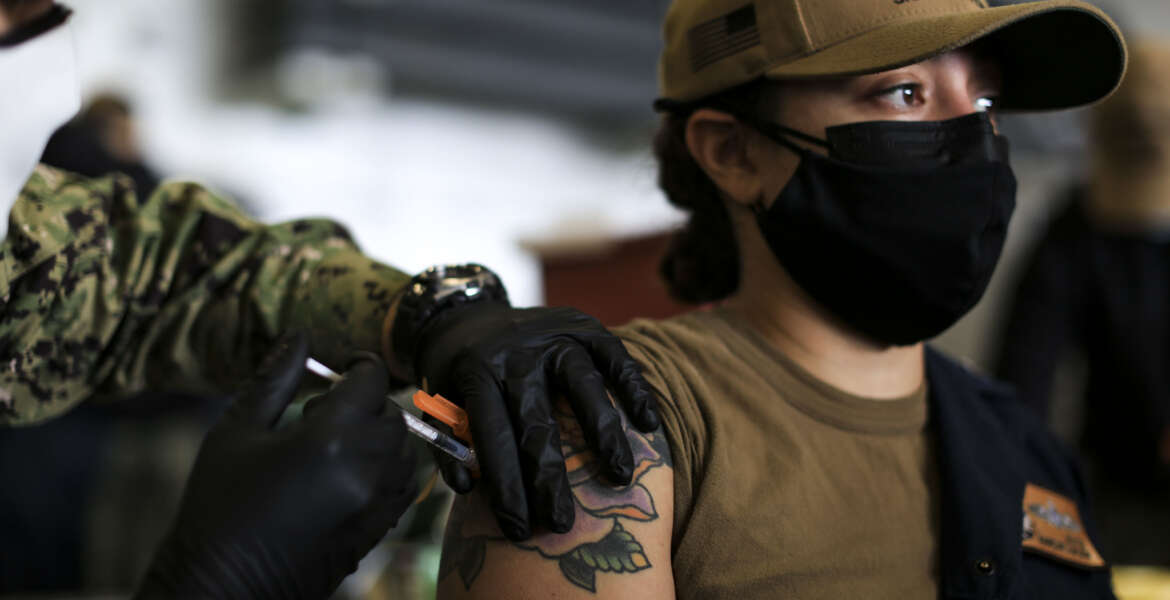 SAN DIEGO (Dec. 28, 2021) Machinist’s Mate (Nuclear) 1st Class Kayla Matos, from Brooklyn, N.Y., receives a COVID-19 booster shot in the hangar bay aboard the aircraft carrier USS Abraham Lincoln (CVN 72). Though not mandatory, the Navy recommends all Navy personnel receive the COVID-19 vaccine booster. (U.S. Navy photo by Mass Communication Specialist 3rd Class Lake Fultz) 211228-N-DN347-1008