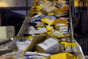 Parcels jam a conveyor belt at the United States Postal Service sorting and processing facility, Thursday, Nov. 18, 2021, in Boston. On the busiest days, about 170,000 packages are processed at the facility. Last year's holiday season was far from the most wonderful time of the year for the beleaguered U.S. Postal Service. Shippers are now gearing up for another holiday crush.(AP Photo/Charles Krupa)