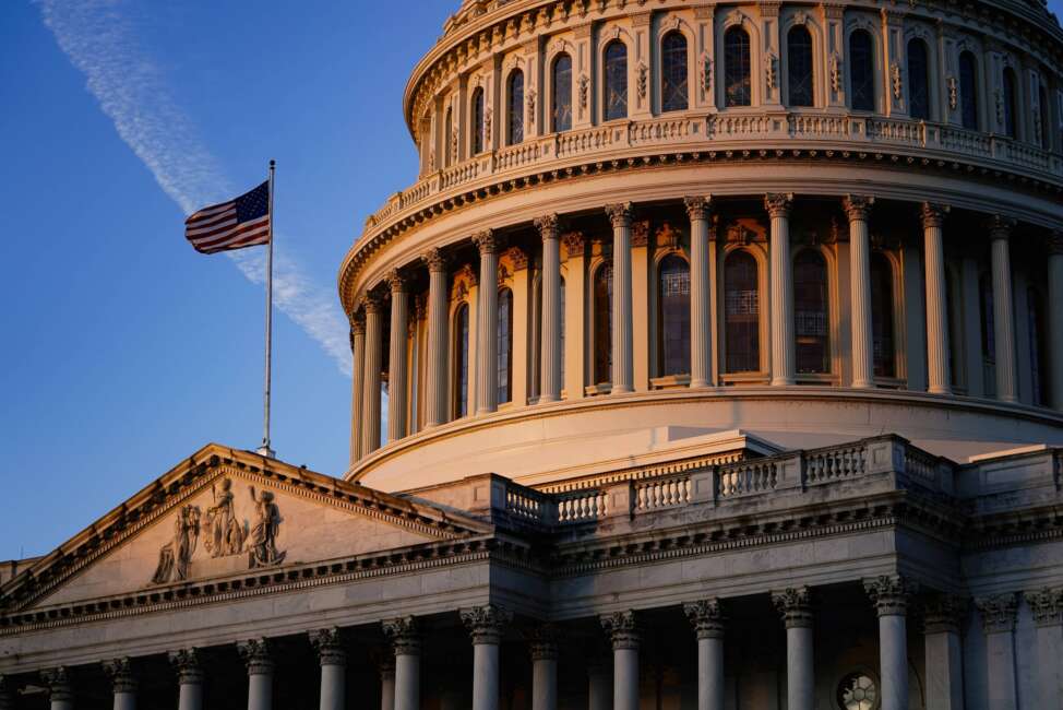 Light from the morning sun illuminates the Capitol in Washington, Friday, Dec. 3, 2021. With Democrats holding a thin majority in Congress, passage of President Joe Biden's sweeping legislative agenda will be a challenge as negotiations continue in the 50-50 Senate. (AP Photo/J. Scott Applewhite)