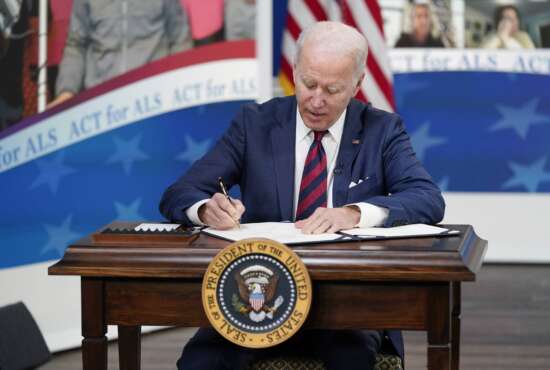 President Joe Biden signs the 