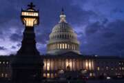 Night falls at the the Capitol in Washington, Thursday, Dec. 2, 2021, with the deadline to fund the government approaching. Republicans in the Senate are poised to stall a must-pass funding bill as they force a debate on rolling back the Biden administration's COVID-19 vaccine mandates for some workers. (AP Photo/J. Scott Applewhite)