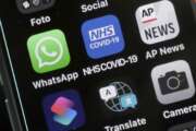 A view of an iphone showing the new NHS COVID-19 mobile phone application after the app went live on Thursday morning in London, Thursday, Sept. 24, 2020.  A new report group says digital contact tracing apps, artificial intelligence and other tech tools that European governments rolled out to combat COVID-19 failed to play a key role in solving the pandemic and now threaten to make such monitoring widely accepted. The nonprofit research group AlgorithmWatch said Thursday, Dec. 9, 2021 that the health surveillance technologies many countries deployed were often adopted without enough transparency, safeguards or democratic debate.  (AP Photo/Frank Augstein, File)