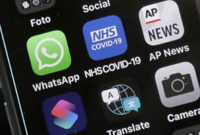 A view of an iphone showing the new NHS COVID-19 mobile phone application after the app went live on Thursday morning in London, Thursday, Sept. 24, 2020.  A new report group says digital contact tracing apps, artificial intelligence and other tech tools that European governments rolled out to combat COVID-19 failed to play a key role in solving the pandemic and now threaten to make such monitoring widely accepted. The nonprofit research group AlgorithmWatch said Thursday, Dec. 9, 2021 that the health surveillance technologies many countries deployed were often adopted without enough transparency, safeguards or democratic debate.  (AP Photo/Frank Augstein, File)