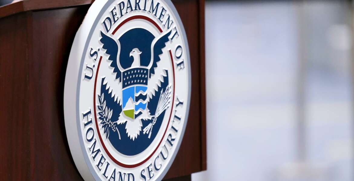 FILE - A U.S. Department of Homeland Security plaque is displayed a podium as international passengers arrive at Miami international Airport where they are screened by U.S. Customs and Border Protection, Nov. 20, 2020, in Miami. A special Customs and Border Protection unit used sensitive government databases intended to track terrorists to investigate as many as 20 U.S.-based journalists, including a Pulitzer Prize-winning Associated Press reporter, according to a federal watchdog. (AP Photo/Lynne Sladky, File)