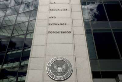 FILE - The U.S. Securities and Exchange Commission building in Washington is seen on Aug. 5, 2017. Chinese companies will have to disclose more information about audits and whether they are controlled by a government or else leave U.S. stock markets under a rule approved by securities regulators, Thursday, Dec. 2, 2021. (AP Andrew Harnik, File)